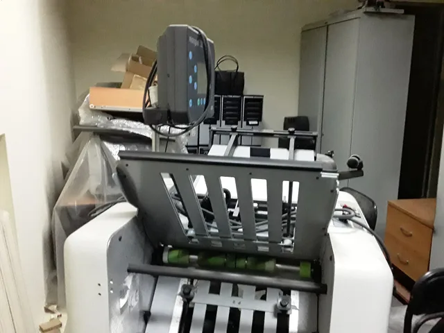 Folder gluer machine BAUM 714XLTD-2-P-6 Microgluer, side view. Used Paper Folder Prices: What to Inspect Before You Buy
